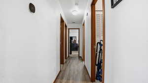 Corridor with light wood finished floors and baseboards
