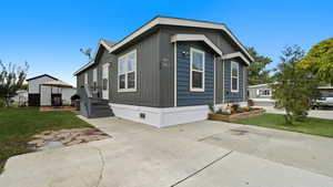 View of home's exterior with a lawn and crawl space