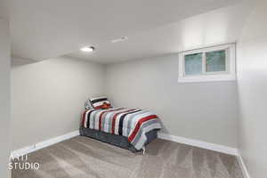 Carpeted bedroom with a textured ceiling