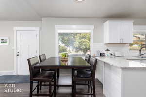 Dining area featuring dark wood-style flooring