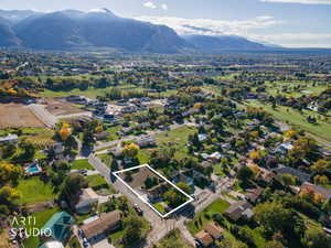 Aerial view of property and surrounding area with property parcel outlined and nearby suburban area