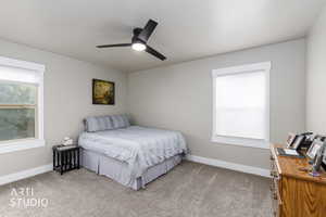 Bedroom featuring light carpet and a ceiling fan