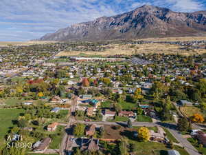 Aerial view of property's location with nearby suburban area and a mountainous background