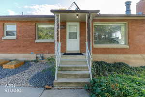 Property entrance featuring brick siding