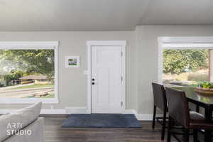 Foyer entrance featuring dark wood-type flooring and a textured ceiling