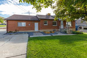 Ranch-style house featuring a front lawn, brick siding, and a shingled roof
