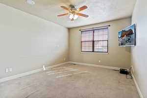 Unfurnished room with carpet floors, a textured ceiling, and ceiling fan