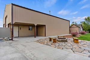 View of front of property with an outdoor fire pit and a patio