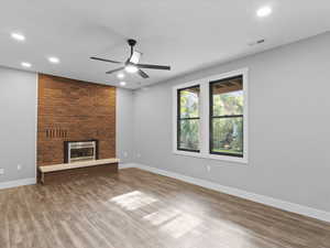 Unfurnished living room with recessed lighting, a fireplace, a ceiling fan, and light wood-type flooring