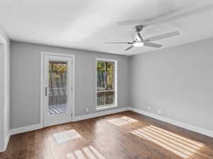Primary bedroom with doorway to outside space