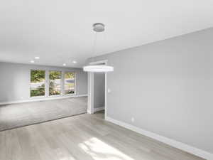 Unfurnished living room featuring light wood-style flooring and recessed lighting