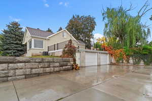 View of property exterior with driveway and a balcony