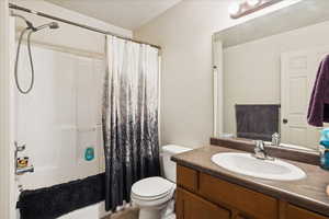 Full bath featuring shower / tub combo with curtain, vanity, and tile patterned flooring