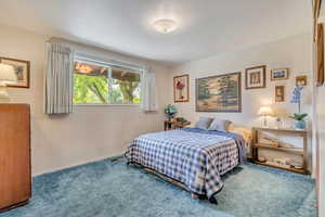 Primary Bedroom with carpet and baseboards