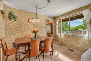 Dining room featuring wallpapered walls and a mountain view