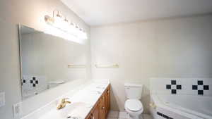 Full bathroom featuring vanity, a garden tub, and light tile patterned floors