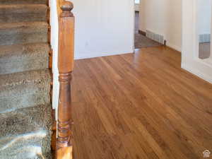 Stairs with wood-type flooring and baseboards