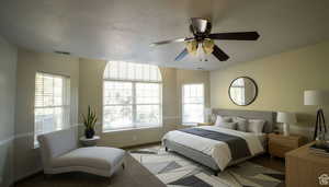 Bedroom featuring a textured ceiling, a ceiling fan, and carpet flooring