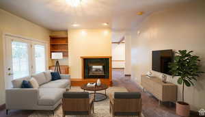 Living area with a tile fireplace and carpet flooring