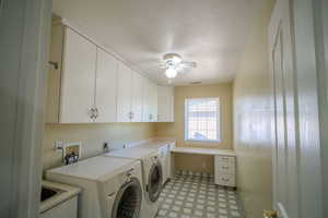 Washroom featuring a textured ceiling, independent washer and dryer, light floors, cabinet space, and a ceiling fan