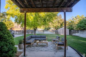 Fenced backyard with a pergola, a shed, a patio area, and an outdoor living space