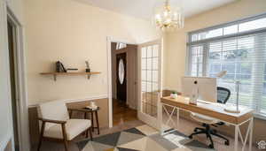Office with a chandelier and french doors