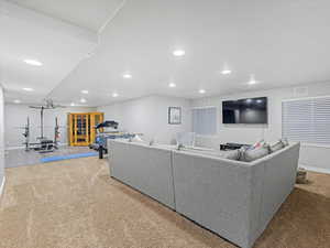 Living area with carpet floors and recessed lighting