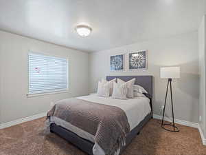 Carpeted bedroom featuring baseboards