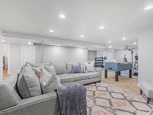 Living area with light colored carpet and recessed lighting