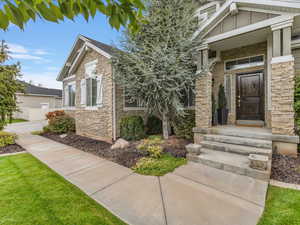 Property entrance with stone siding and board and batten siding