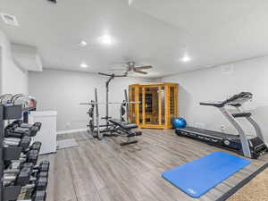 Exercise area featuring recessed lighting, wood finished floors, and a ceiling fan