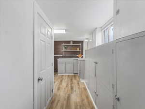 Hall featuring light wood finished floors