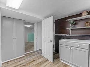 Bathroom featuring light wood-style flooring and a closet