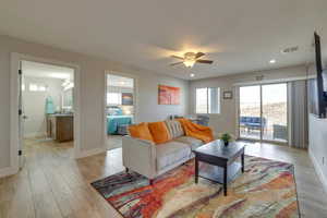 Living area with plenty of natural light, light wood-style flooring, a ceiling fan, and recessed lighting
