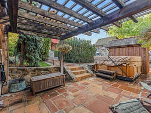 View of patio featuring a hot tub and a pergola