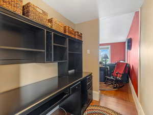 Office with light wood-type flooring and baseboards
