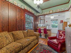 Living area featuring light wood-type flooring and crown molding