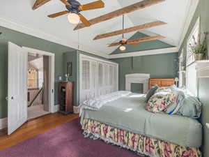 Primary Bedroom featuring ornamental molding, wood finished floors, a ceiling fan, and a closet