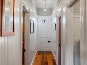 Doorway featuring hardwood / wood-style flooring and baseboards