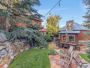 View of grassy yard with a patio