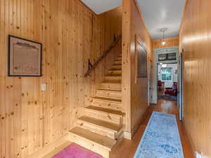 Stairs with wooden walls and wood finished floors