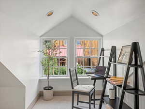 Office space with plenty of natural light, vaulted ceiling, and recessed lighting
