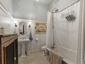 Mother in law Full bath with shower / bath combo with shower curtain and light tile patterned floors