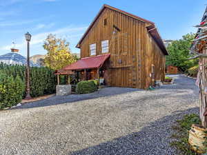 View of front of house featuring board and batten siding, a metal roof, and a mountain view