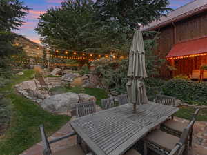 Patio terrace at dusk featuring a patio area and outdoor dining space