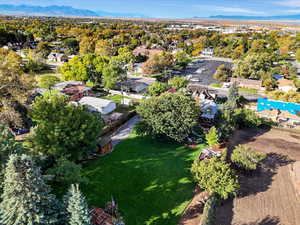 Aerial view of property's location with a mountain backdrop and nearby suburban area