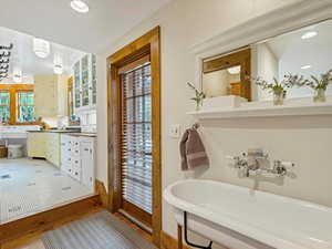 Bathroom featuring recessed lighting, light wood-style floors, and double vanity
