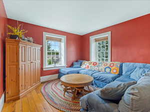 Living area featuring hardwood / wood-style flooring and baseboards