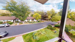 View of asphalt road featuring curbs