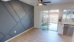 Unfurnished dining area featuring light wood-style flooring and a ceiling fan